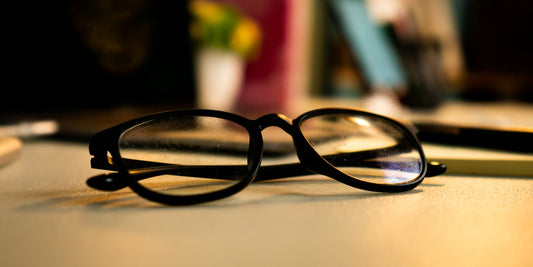 an AI glasses placed on a wood desk