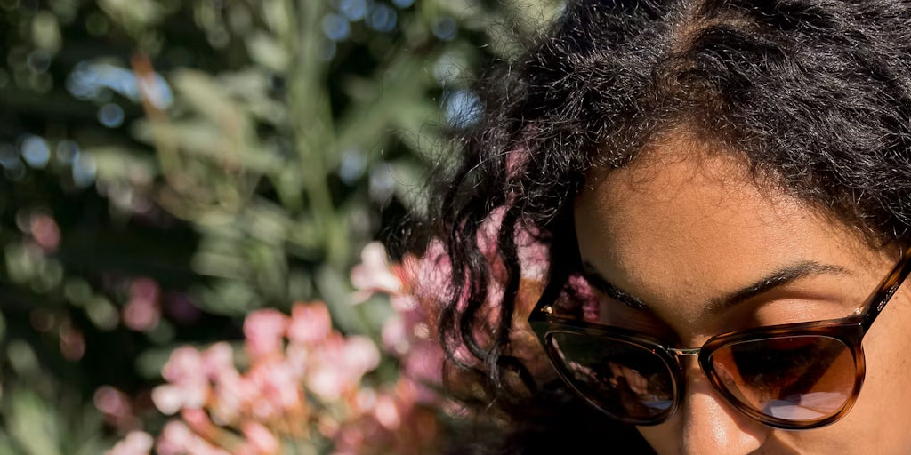 a black lady wearing a pair of sunglasses
