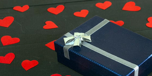 a gift box surrounded by red heart