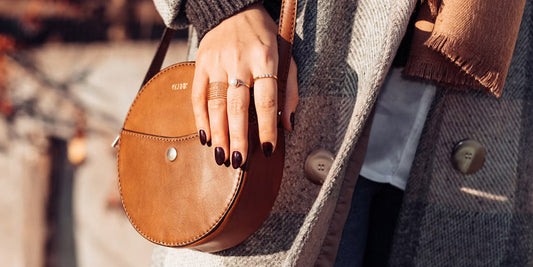 a lady holding a leather bag