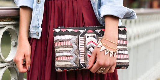 a lady taking a leather clutch walking on a street