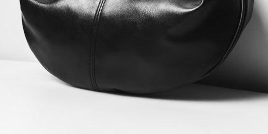 a leather clutch along with the wall