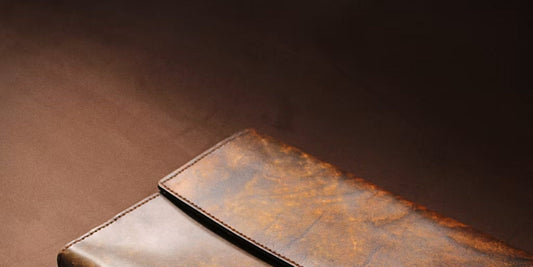 a leather clutch lying on a desk