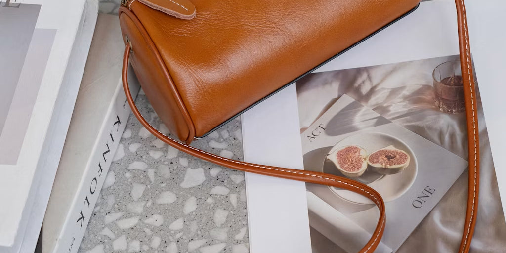 a leather crossbody bag on a magazine