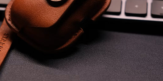 a leather ear phone case on a keyboard