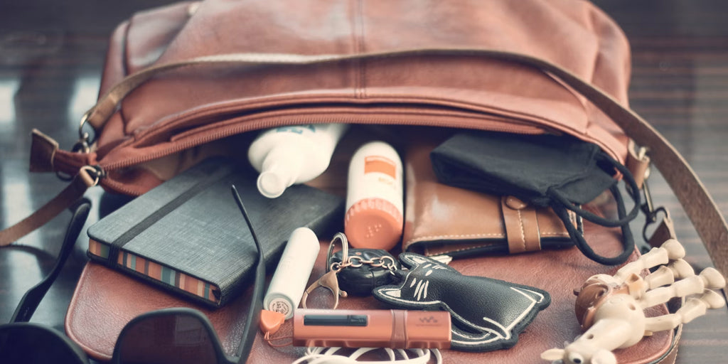 a leather organizer bag on a desk