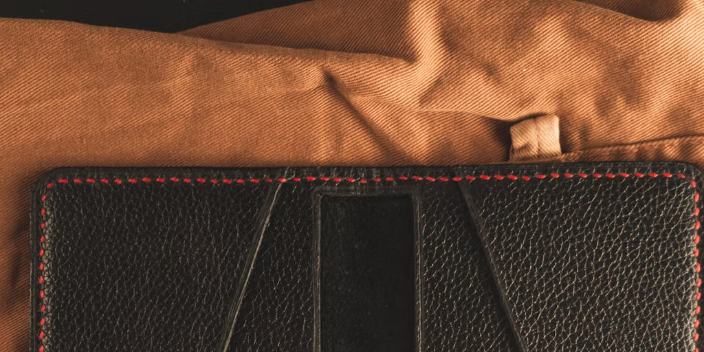 a leather wallet lying on a cloth