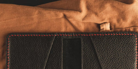 a leather wallet lying on a cloth