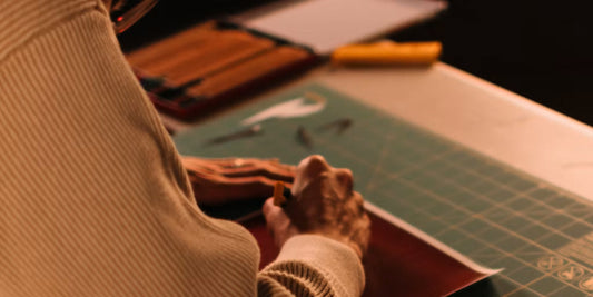 a man hand crafting a leather