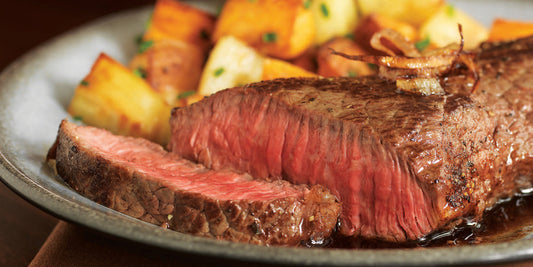 grilled chuck steaks and fried potato on a dish to show how to grill chuck steaks