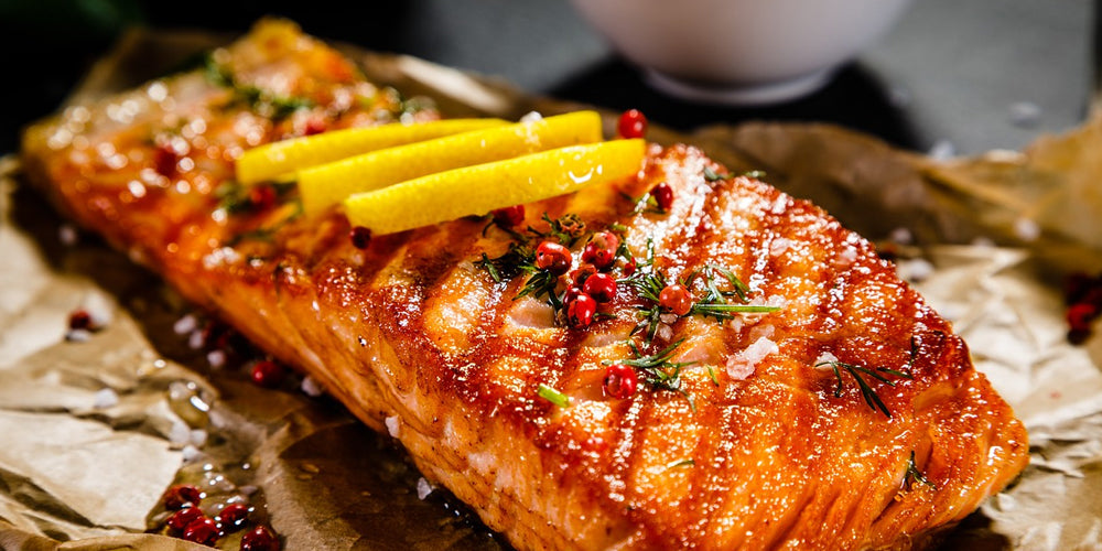 A cut of grilled salmon on a plate to show how to grill salmon with a meat thermometer