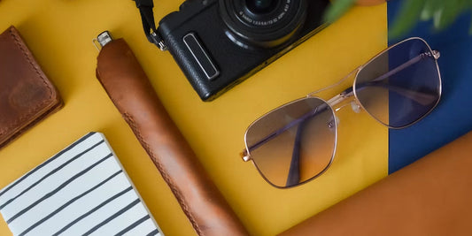 leather pen sleeve and bag on a desk