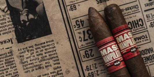 two premium cigars on a newspaper
