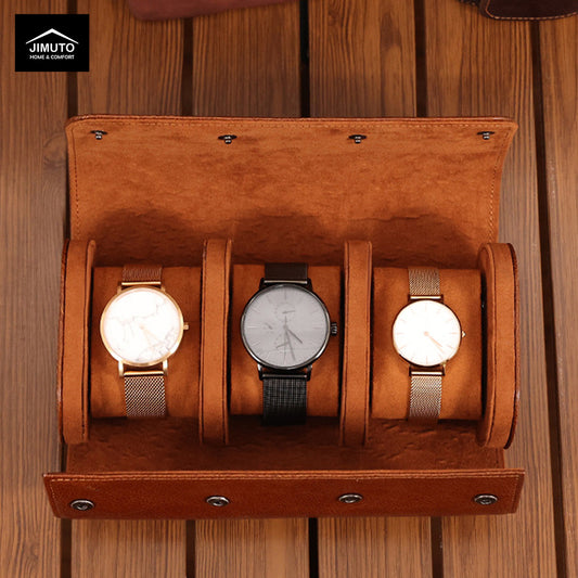 Three watches in a brown leather watch case on a wooden surface, with 'JIMUTO' branding.