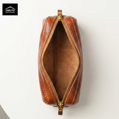 A top-down view of a brown leather zippered pen pouch with gold-tone hardware, shown open on a white background. The Jimuto brand logo is visible in the top-left corner.
