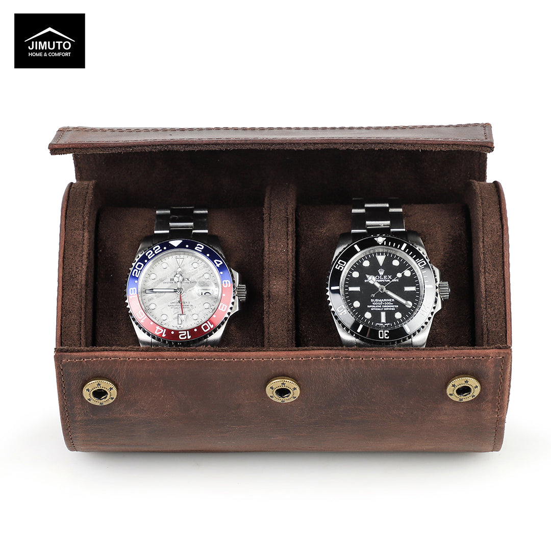 Two watches in a brown leather watch display case with JIMUTO branding.