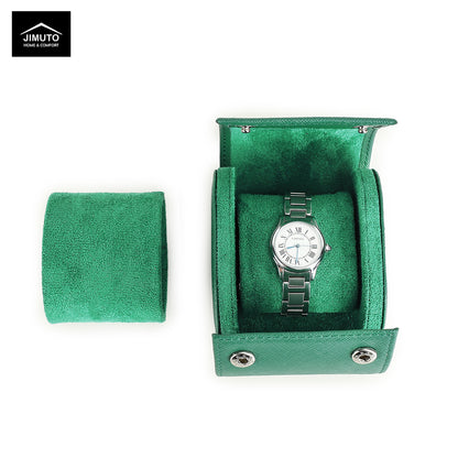 Green saffiano leather watch case with a silver watch inside on a white background