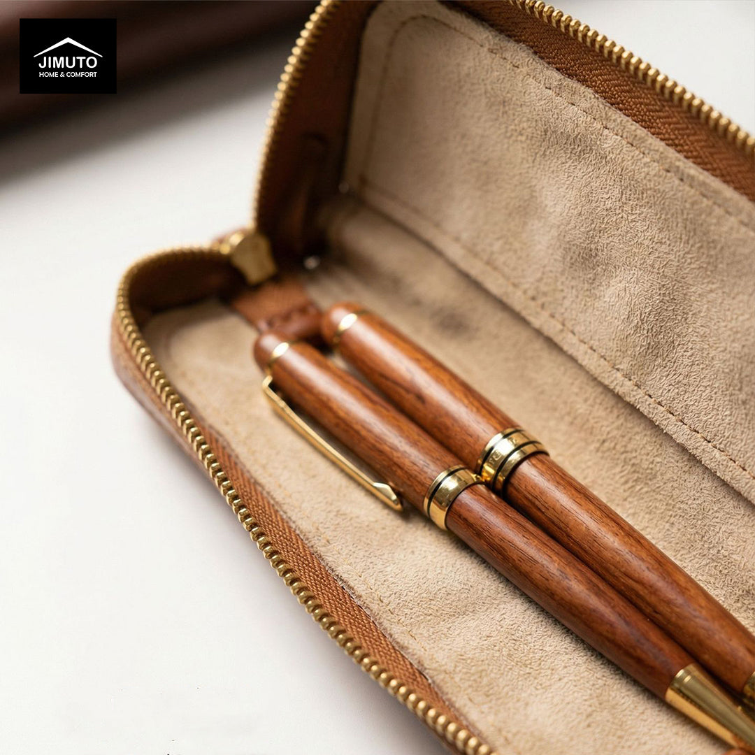 Wooden pen with gold accents in a brown leather pen case on a light background