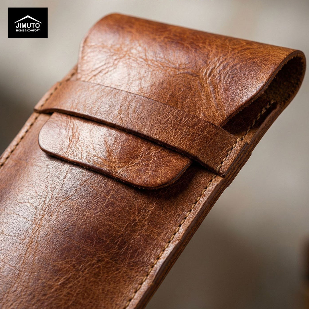 Close-up of a brown leather pen pouch with a blurred background