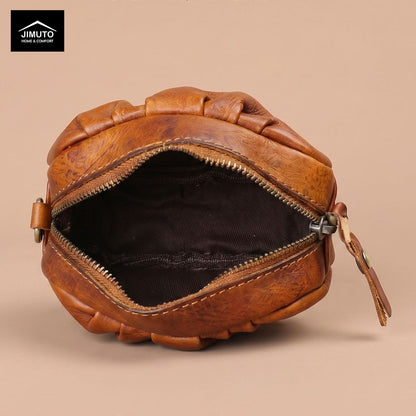 Brown leather bag with zipper on a beige background, featuring the JIMUTO brand.