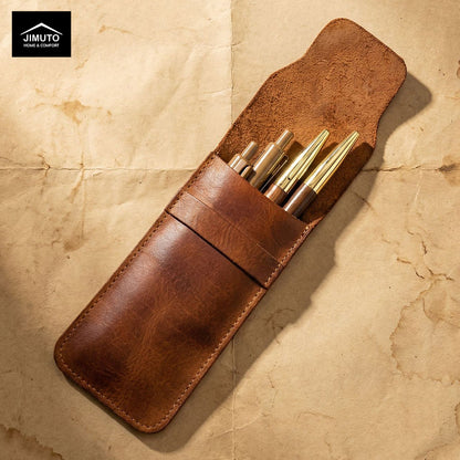Brown leather pen holder with gold pens on a beige textured background, featuring the Jimuto brand.