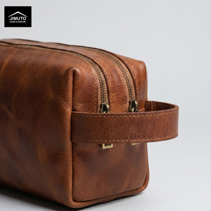 Brown leather storage bag with gold zipper on a light gray background, featuring the JIMUTO brand.