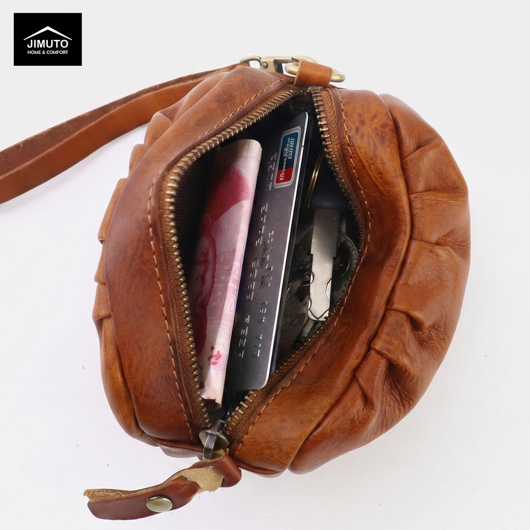 Brown leather pouch with zipper, containing money and a card, on a white background.