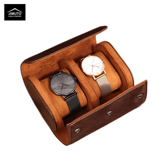 Brown leather watch box with two watches inside on a white background