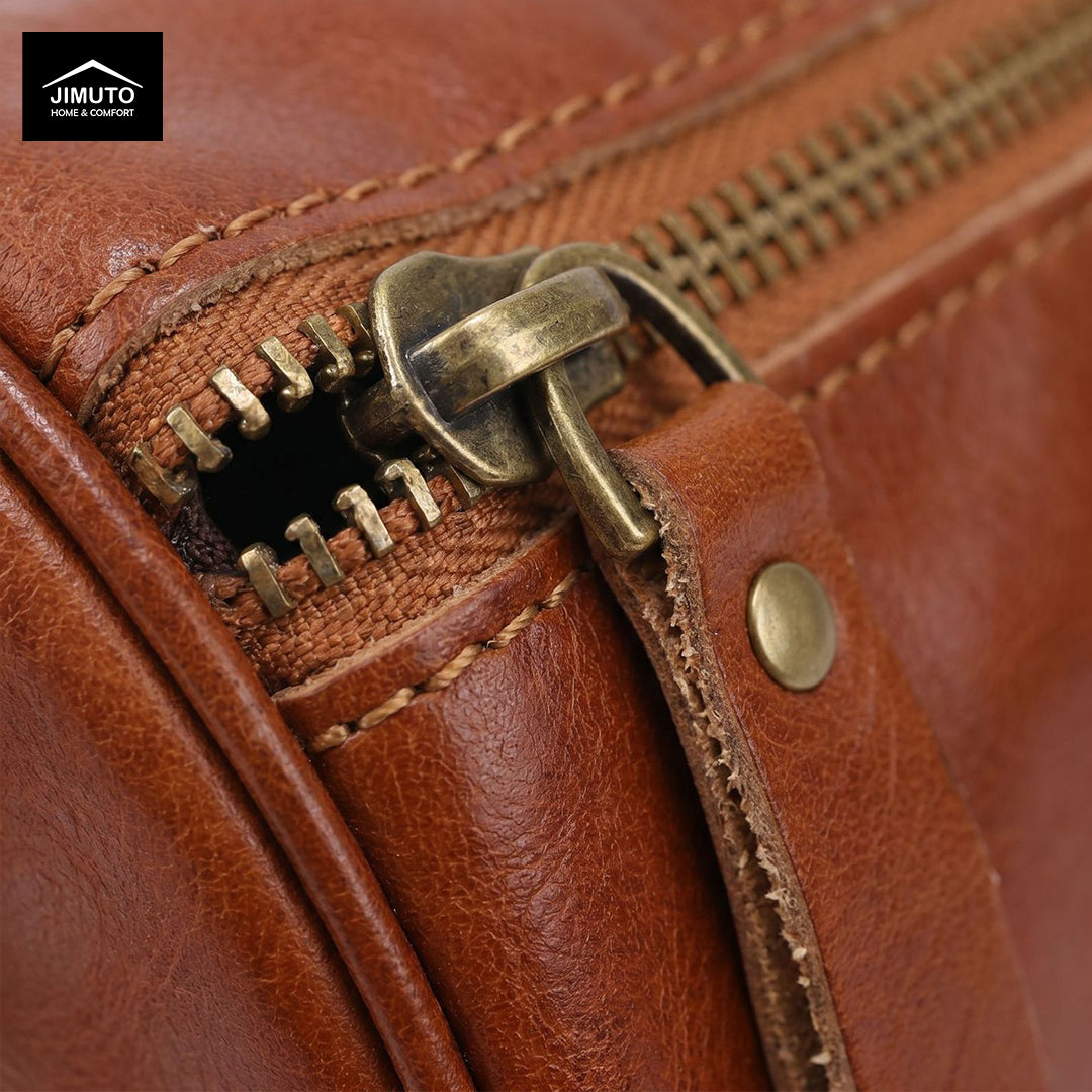 Close-up of a brown leather cosmetic and storage bag with brass zipper and stitching details, featuring the JIMUTO brand.