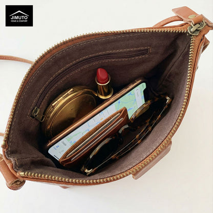 an opening Brown leather crossbody bag  with makeup , wallet, iphone and sunglasses