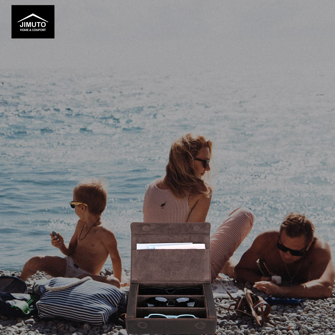 Family sitting on a beach with a JIMUTO leather sunglasses box in the foreground