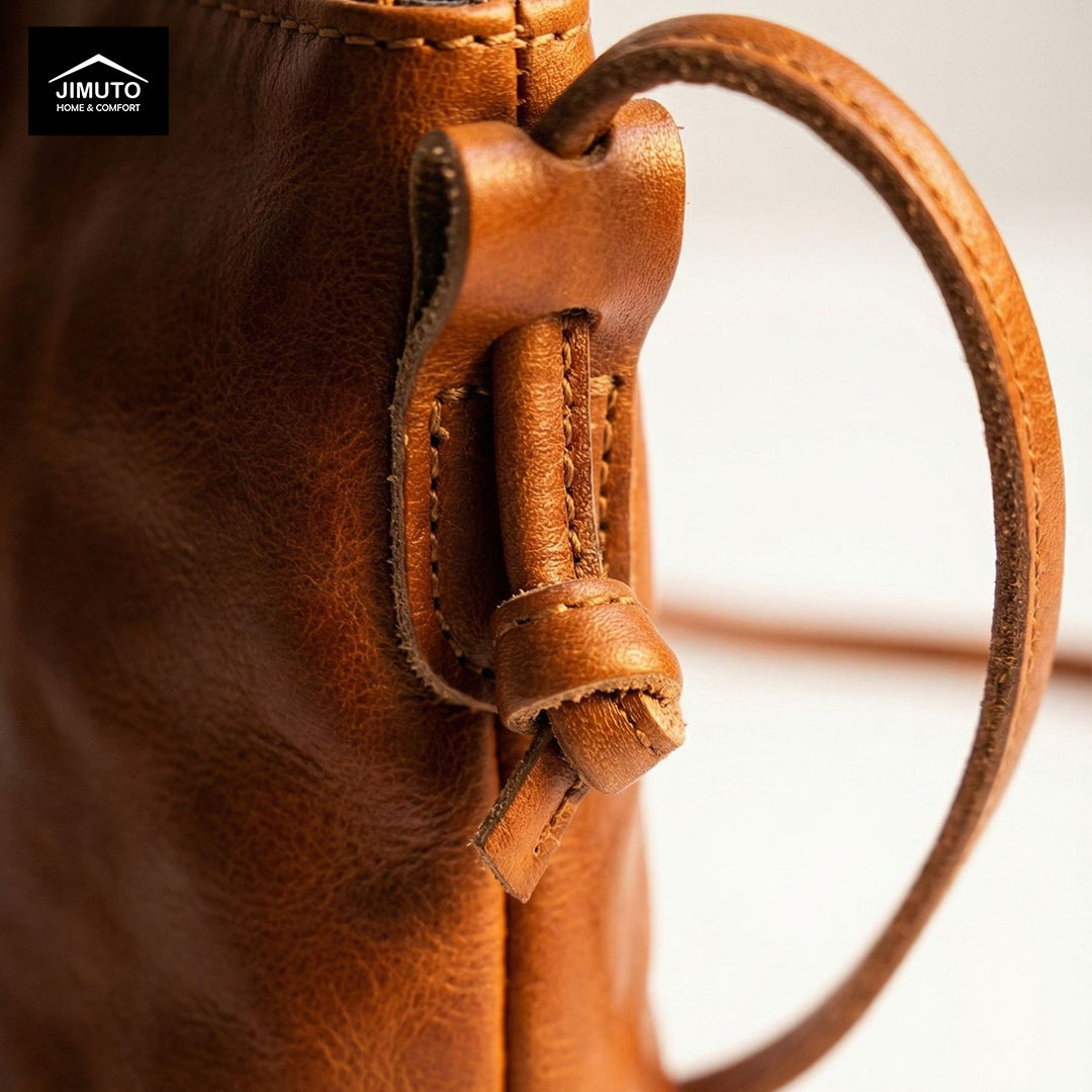 details of a Brown leather crossbody bag on a white background with 'JIMUTO' 