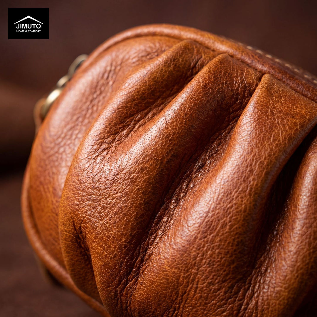 Close-up of a brown leather clutch with 'JIMUTO' branding.