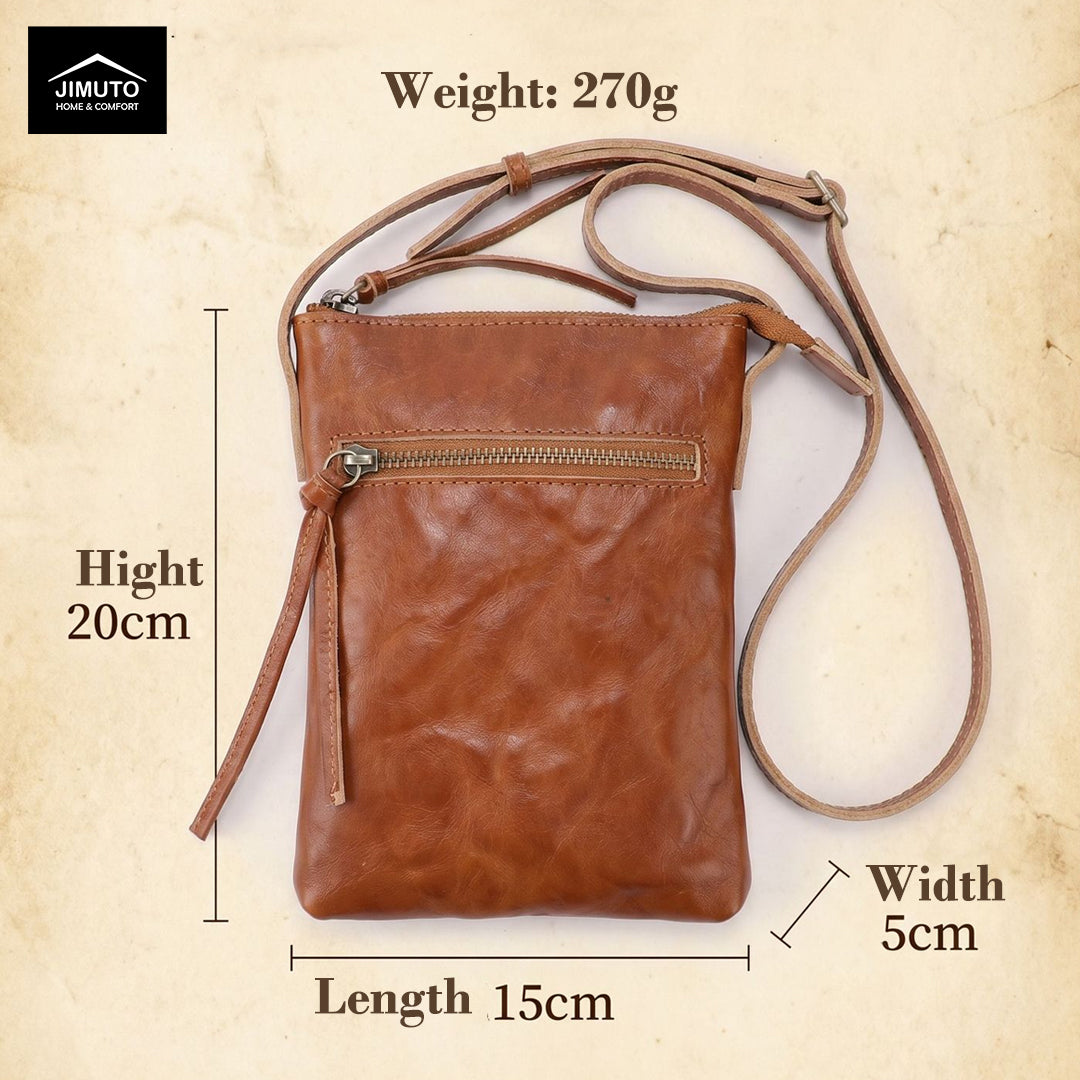 Brown leather crossbody bag with measurements and weight on a beige background