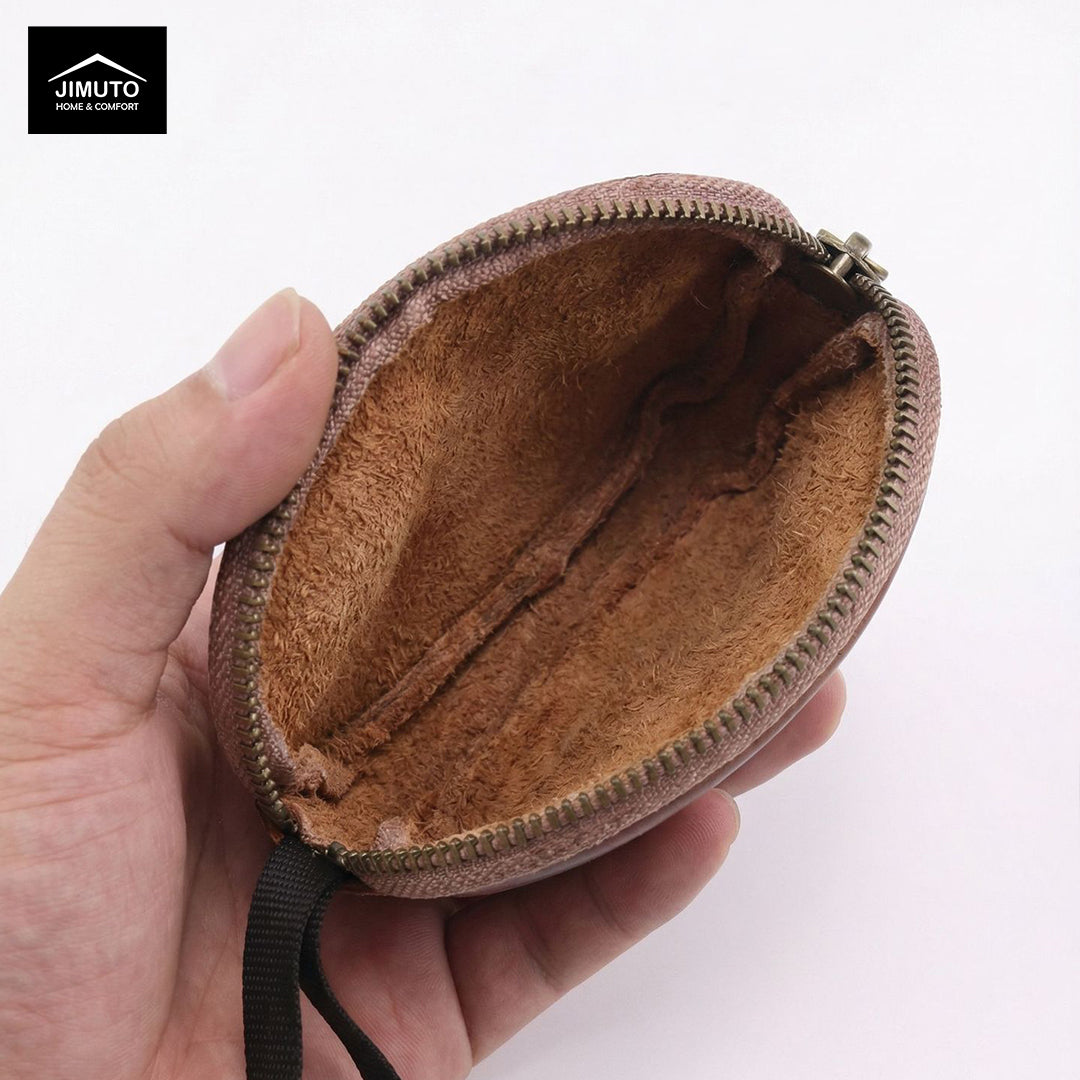 Brown leather coin purse held in a hand with a white background