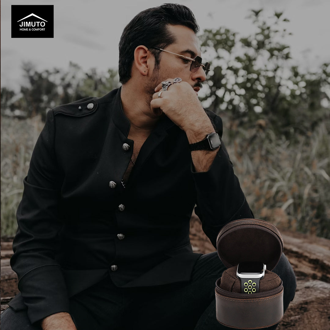 Man in black shirt sitting outdoors with a watch in an open leather watch box