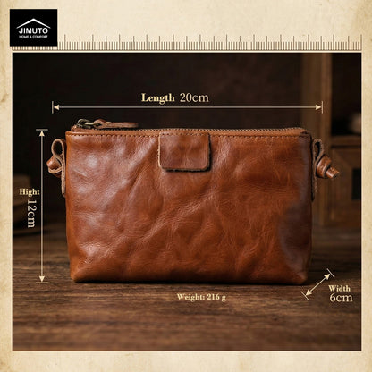 Brown leather crossbody bag on a wood desk with dimensions 