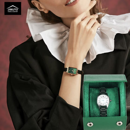 Woman wearing a watch with a green saffiano leather watch case on a red background