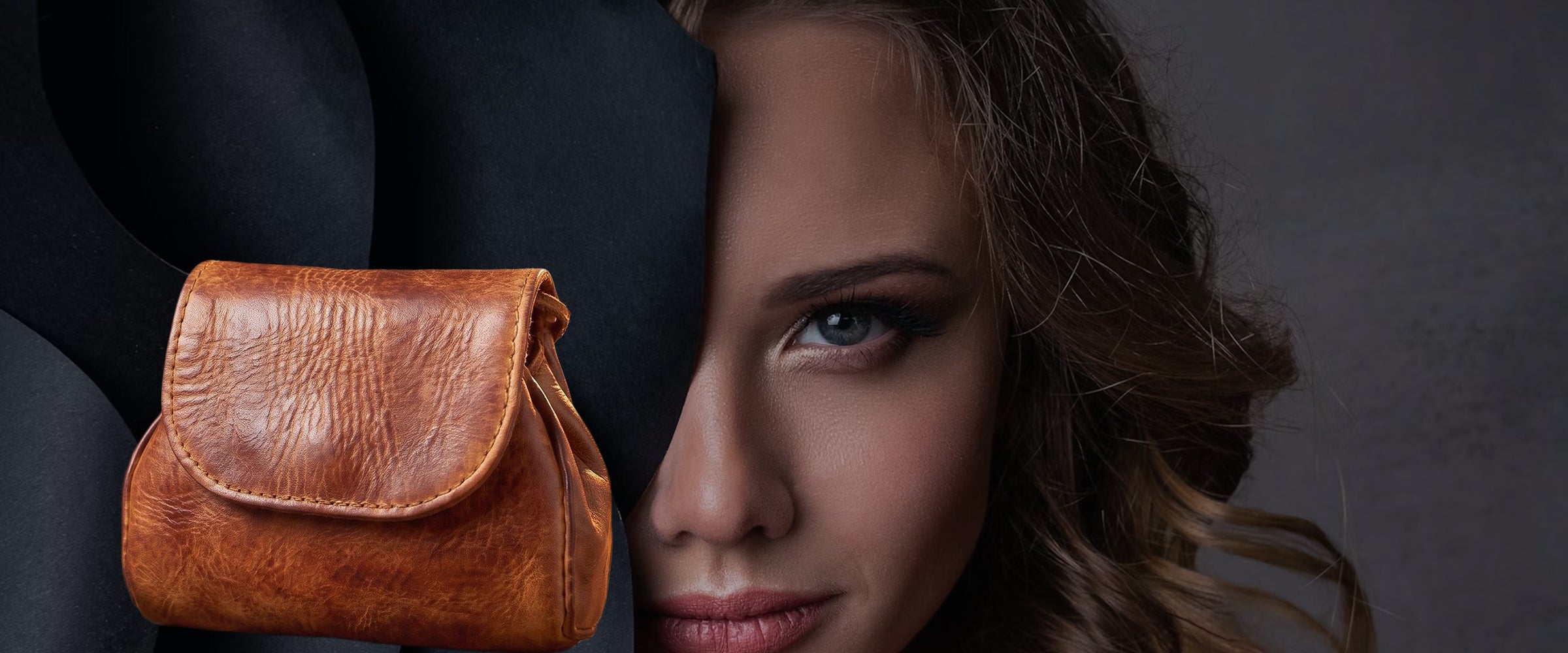 A brown leather pouch stands in front of a fashion lady model.