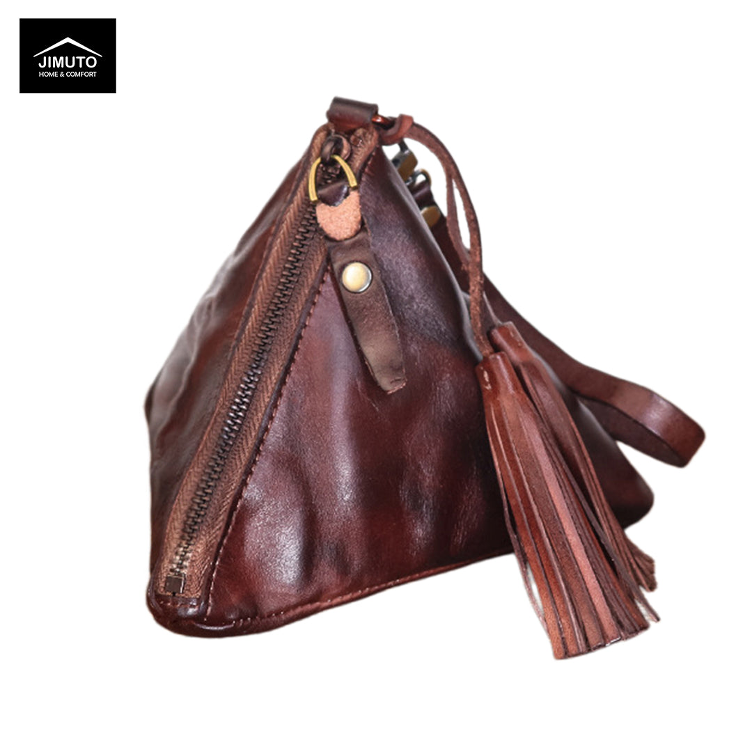 A dark brown leather clutch with a prominent tassel and a diagonal zipper, shown on a white background with a Jimuto logo in the top-left corner.