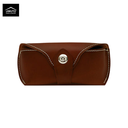 A red brown leather eyeglasses case with white contrast stitching and a silver snap button closure, shown on a plain white background. The Jimuto logo is visible in the top-left corner.