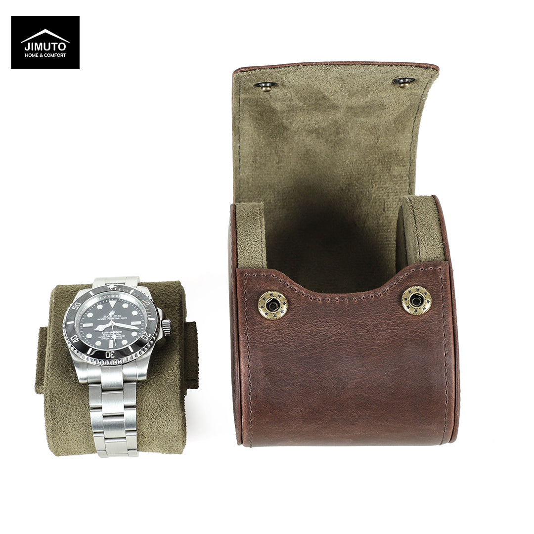 A brown leather watch pouch shown open next to a silver metal watch on a matching olive-green display stand, on a white background. The Jimuto brand logo is visible in the top-left corner.