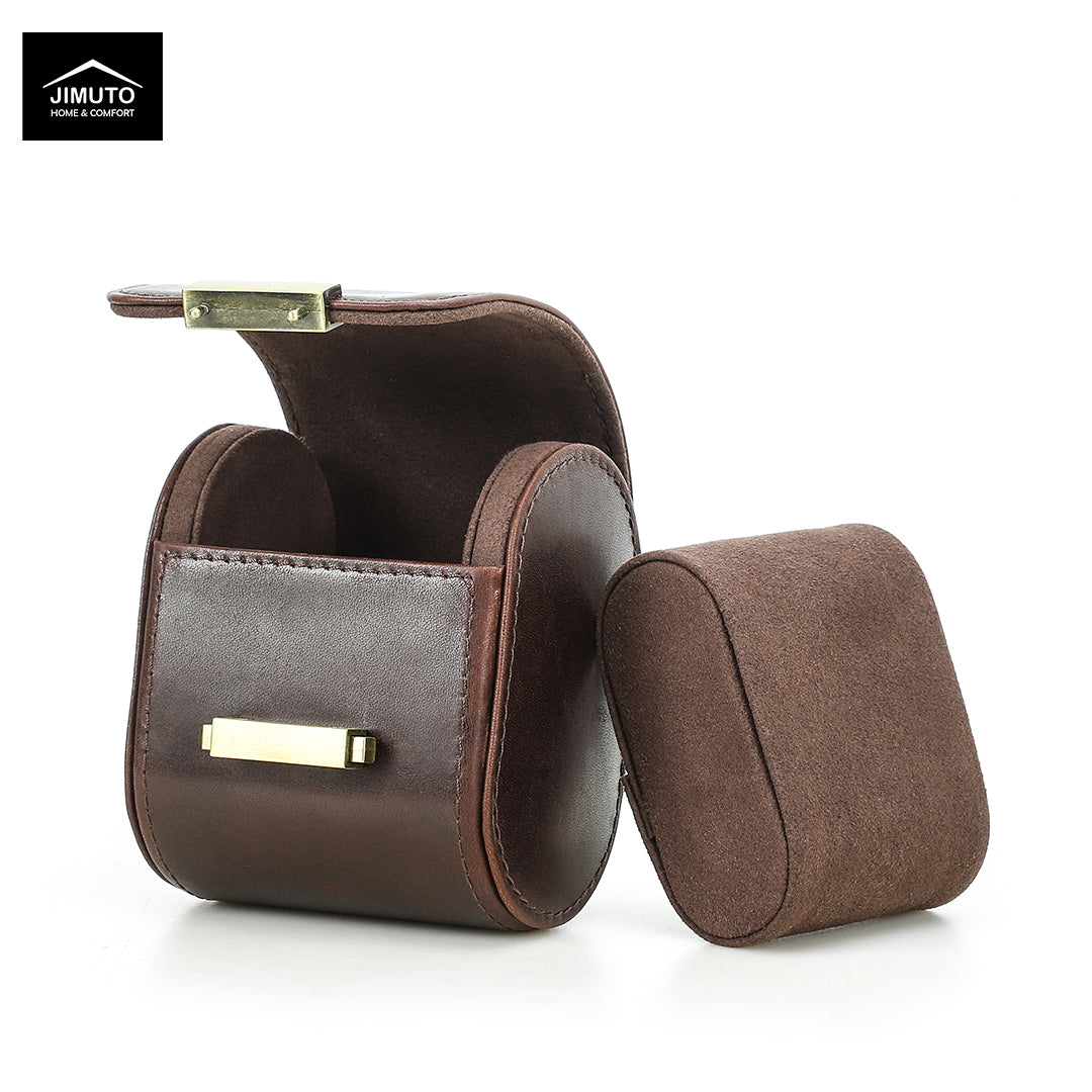 A brown full-grain leather watch box shown open with its lid leaning against the base, on a clean white background. A black logo for 'JIMUTO Jewelry & Accessories' is visible in the top-left corner.