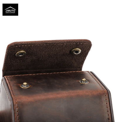 Close-up of a dark brown hexagonal leather watch box with a hinged flap and brass-tone rivets, shown on a white background with a Jimuto logo in the top-left corner.