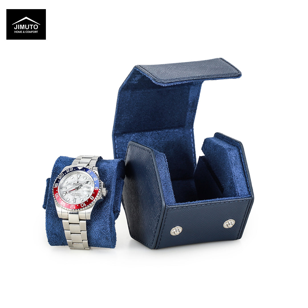 A silver stainless steel watch with a silver link bracelet and a blue, red, and black bezel sits on a blue velvet wristlet cushion next to an open matching blue saffiano leather watch box. The Jimuto brand logo is visible in the top-left corner.