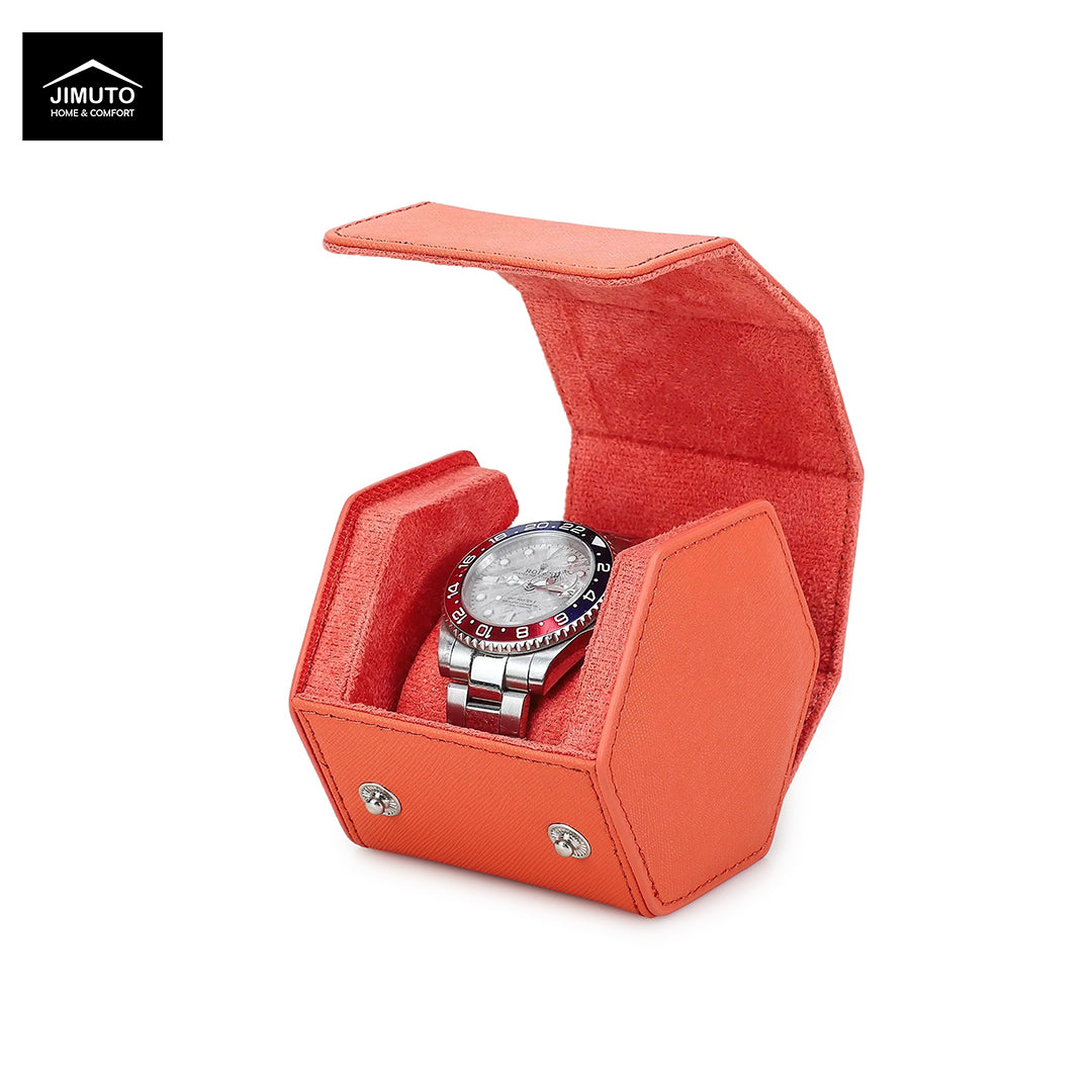 An orange saffiano leather watch box with a hinged lid, shown open to display a silver-tone watch inside. The brand logo 'JIMUTO' is visible in the top-left corner.