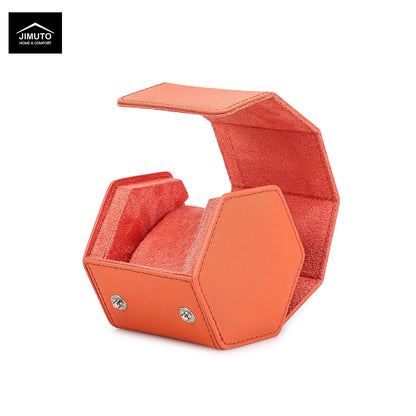 An orange hexagonal leather watch box with an open hinged lid, shown on a white background with a Jimuto brand logo in the top-left corner.