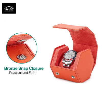 An orange-red textured leather watch box with an open lid, shown on a white background with a watch placed inside. A circular inset highlights a bronze snap closure detail, with text reading 'Bronze Snap Closure' and 'Practical and Firm.