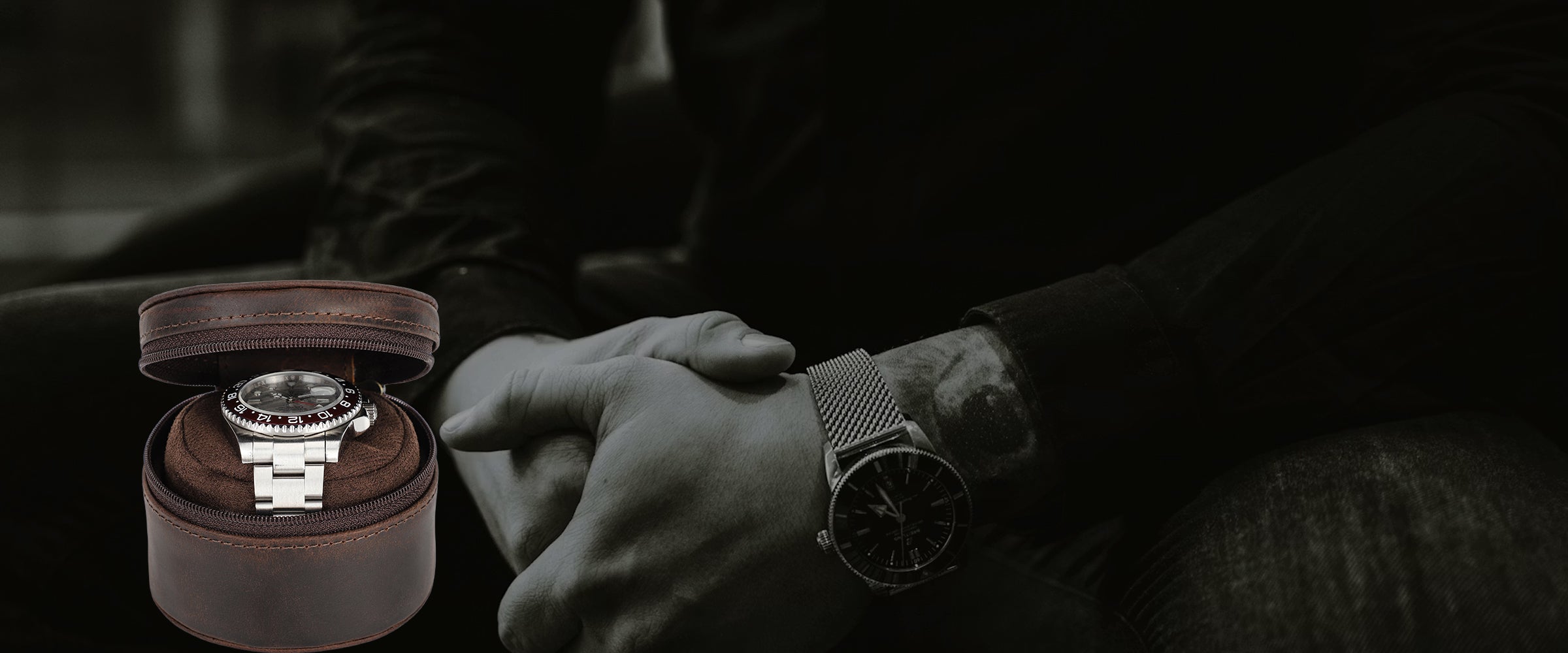 Person holding a watch with a focus on the watch and its leather watch roll.