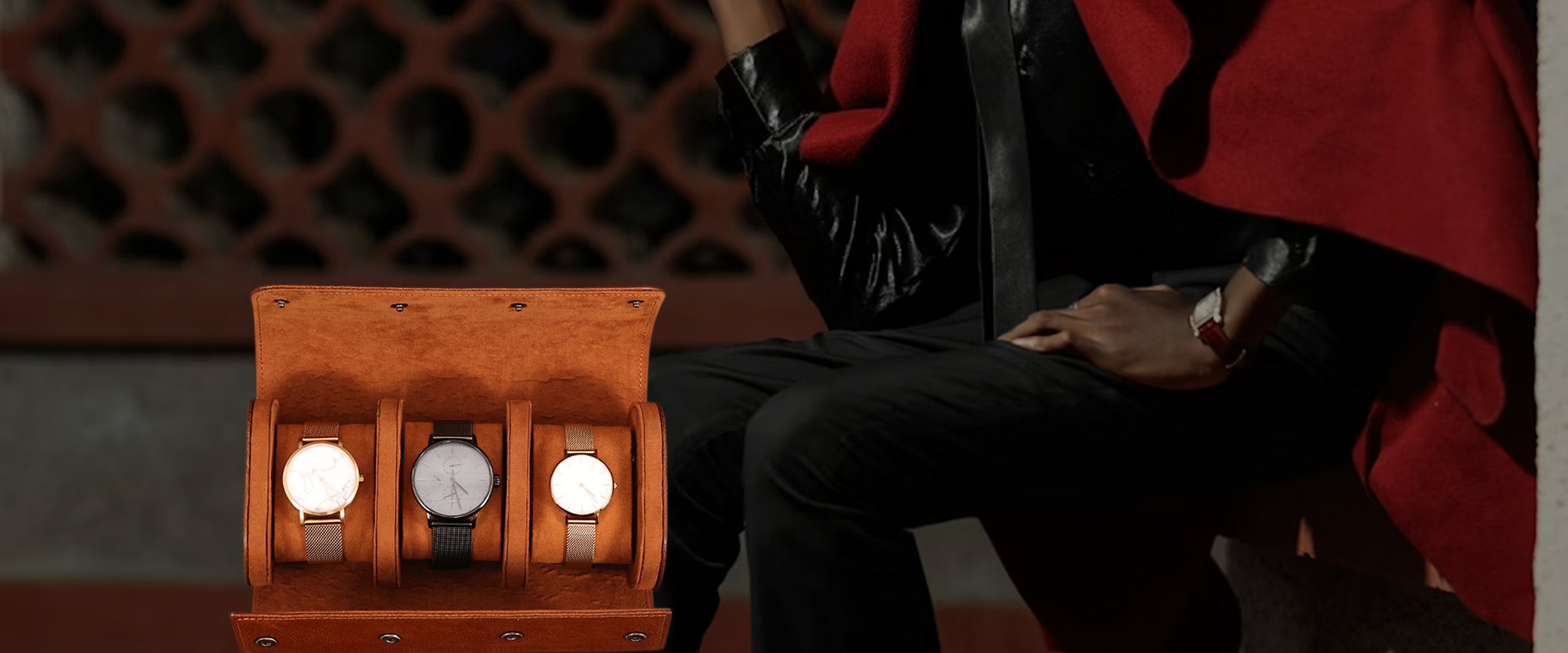Person holding a watch with a leather watch case containing three watches.